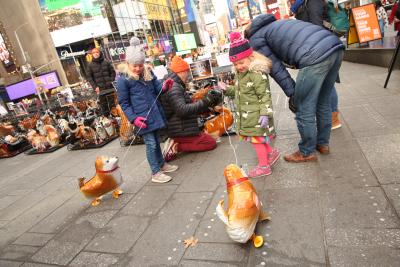 Family with two children, each with a balloon dog at Times Square