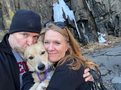 Scott and Vicki Williams with Sunny the dog, while outside