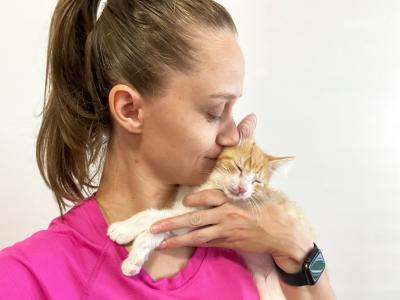 Amanda holding Winter the kitten and kissing her on the cheek