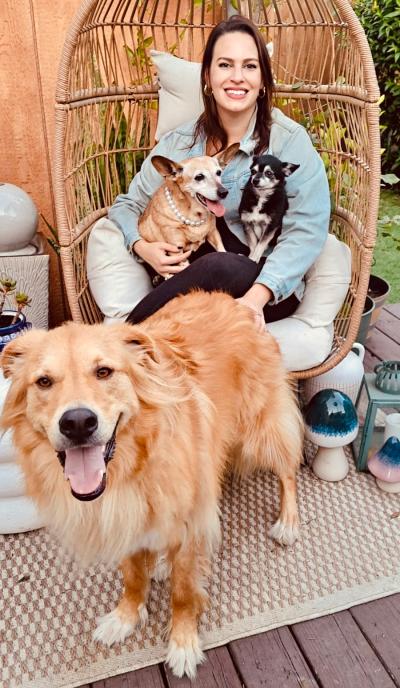 Betty the senior dog (wearing her pearls) with her new family