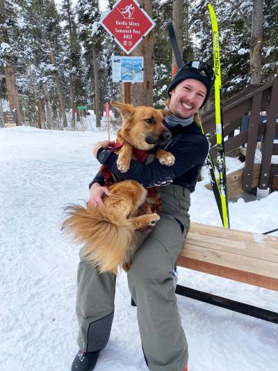 Kimchi the dog being held outside in the snow by Gareth