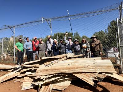 Volunteers from MenHealing with a pile of debris from their cleanup efforts