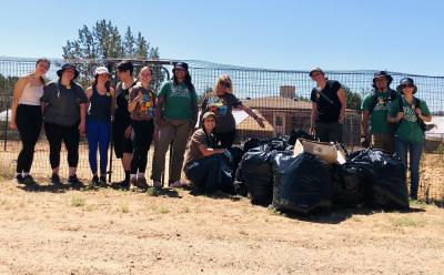 Starbucks volunteers with trash bags they had filled