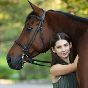 Intern standing next to horse