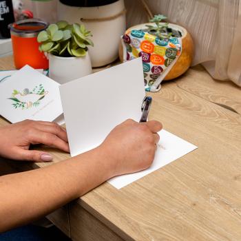 Person sitting at a desk and writing